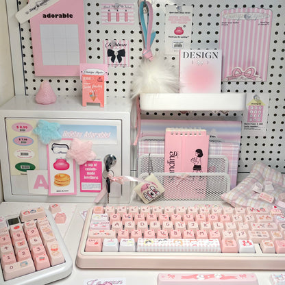 Close-up of cat-themed novelty keycaps in pink and white tones