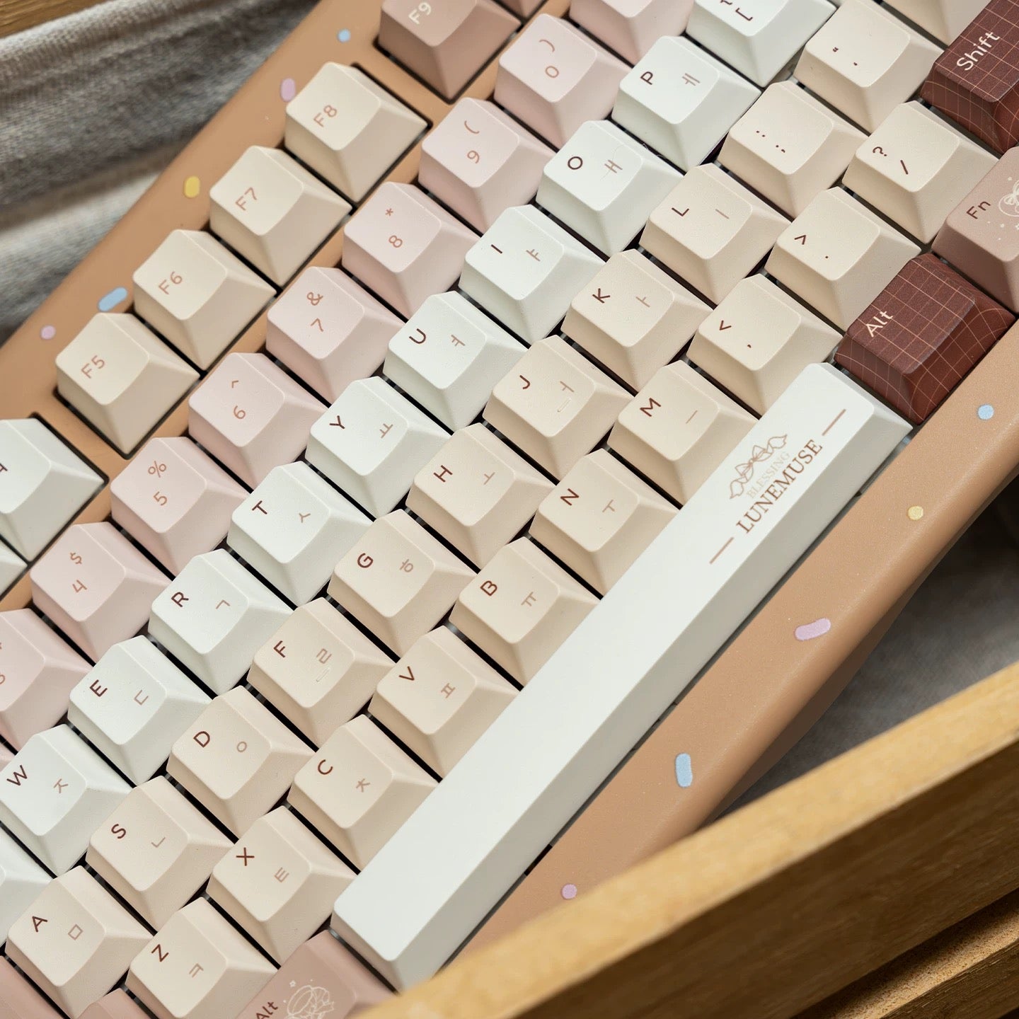 Close-up of PBT keycaps featuring vintage gramophone and dessert icons in Maillard brown tones