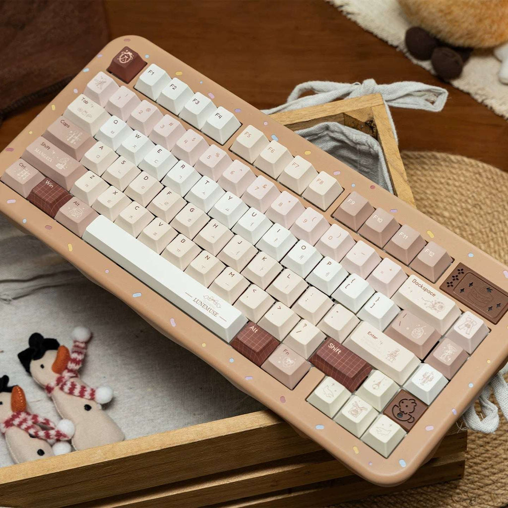 Close-up of PBT keycaps featuring vintage gramophone and dessert icons in Maillard brown tones