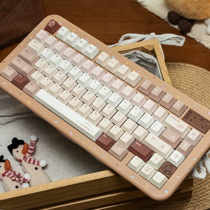 Close-up of PBT keycaps featuring vintage gramophone and dessert icons in Maillard brown tones