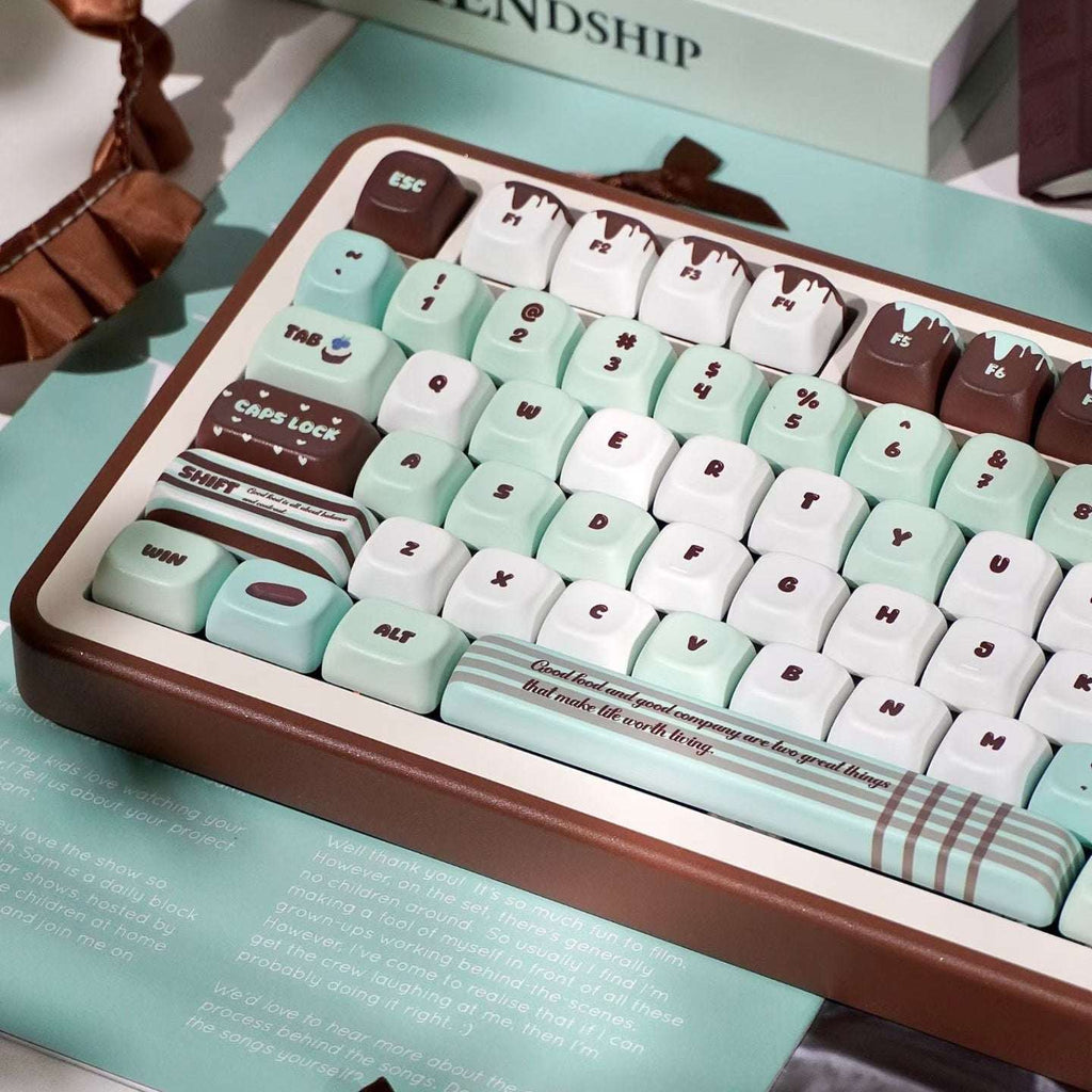 Keyboard with mint green and brown keys on a light blue surface