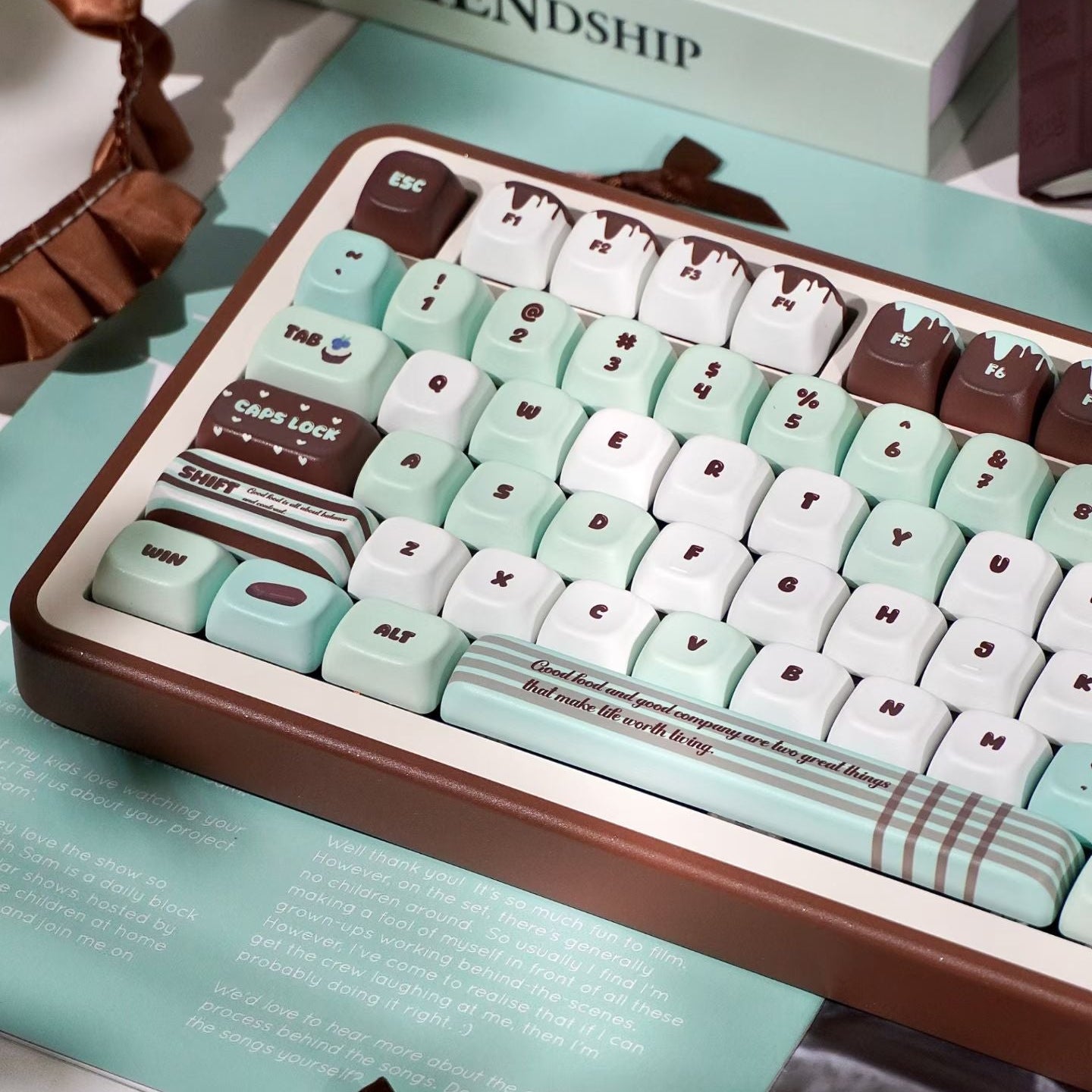 Keyboard with mint green and brown keys on a light blue surface