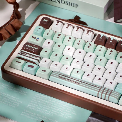 Keyboard with mint green and brown keys on a light blue surface