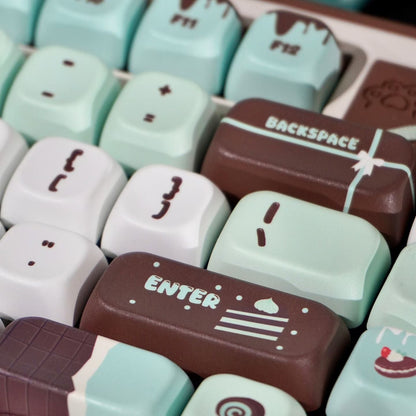 Close-up of cartoonish keyboard keys with cute designs on a brown background