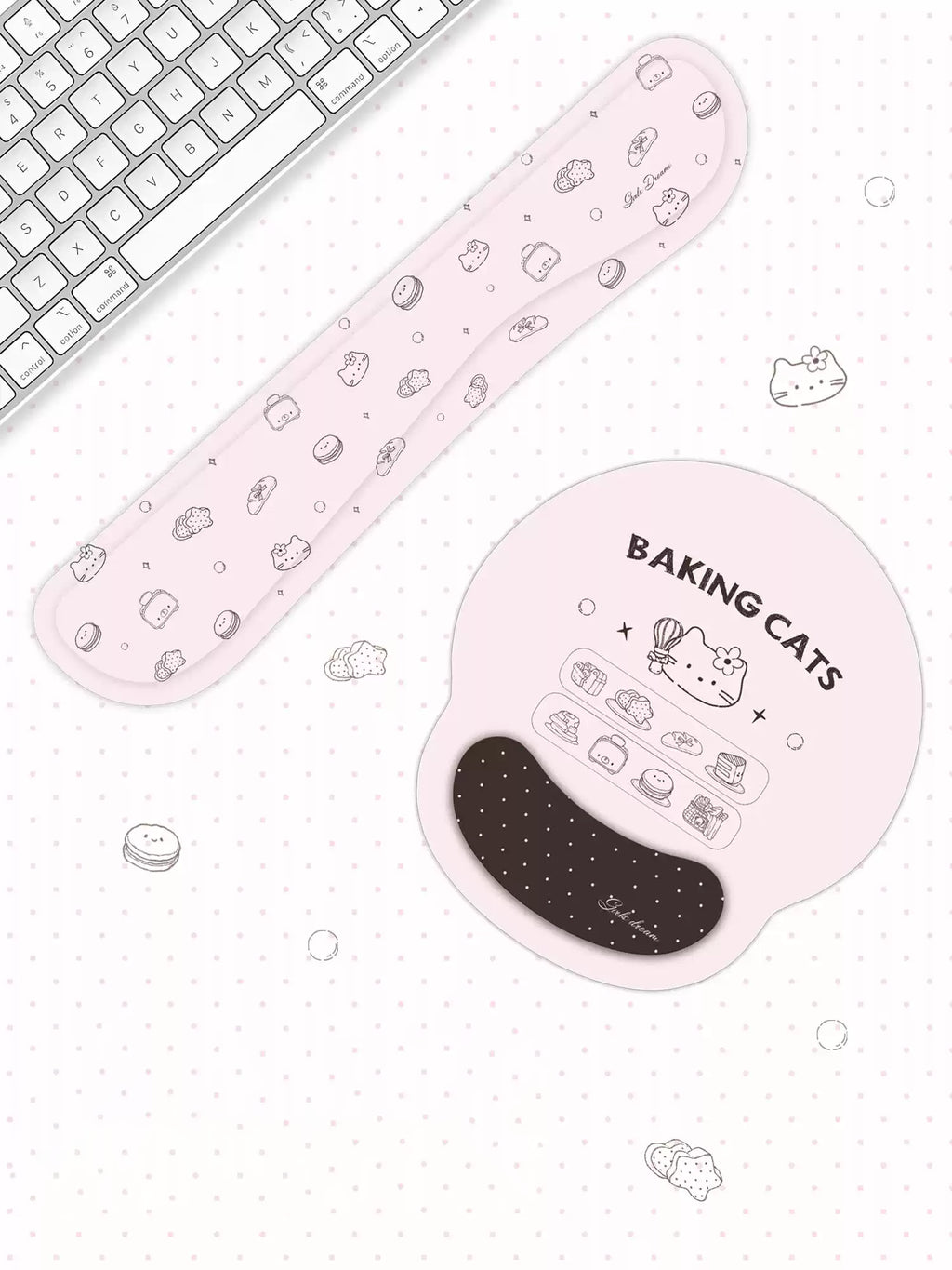 A pink ergonomic wrist rest and matching keyboard pad set with cute baking-themed illustrations, shown on a white polka-dotted desk surface next to a keyboard.