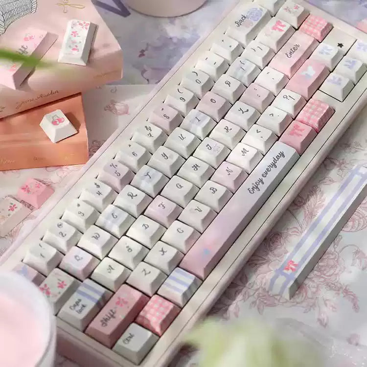 Keyboard with pink and white keys on a floral surface