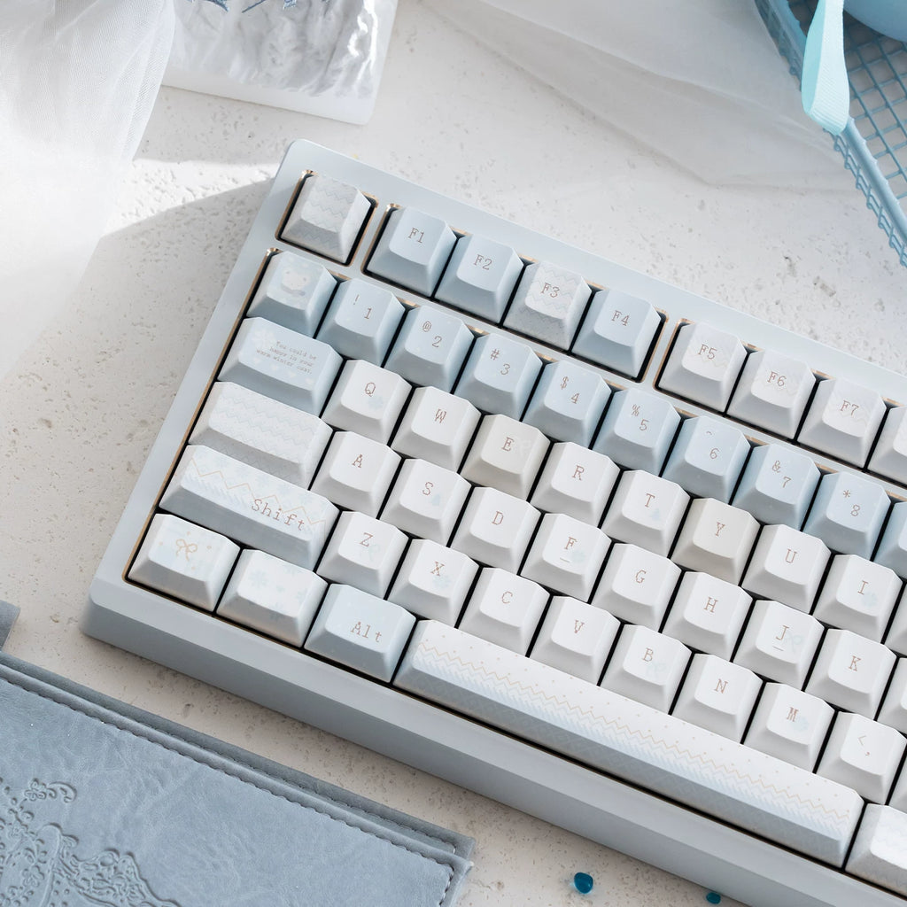 Mechanical keyboard with gray and white keys on a light surface