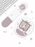 A cute desk accessory set featuring a long, narrow mouse pad and a round mouse pad with a pastel anime girl illustration, both decorated with pink gingham checkers and white polka dots, displayed on a white surface next to a keyboard.