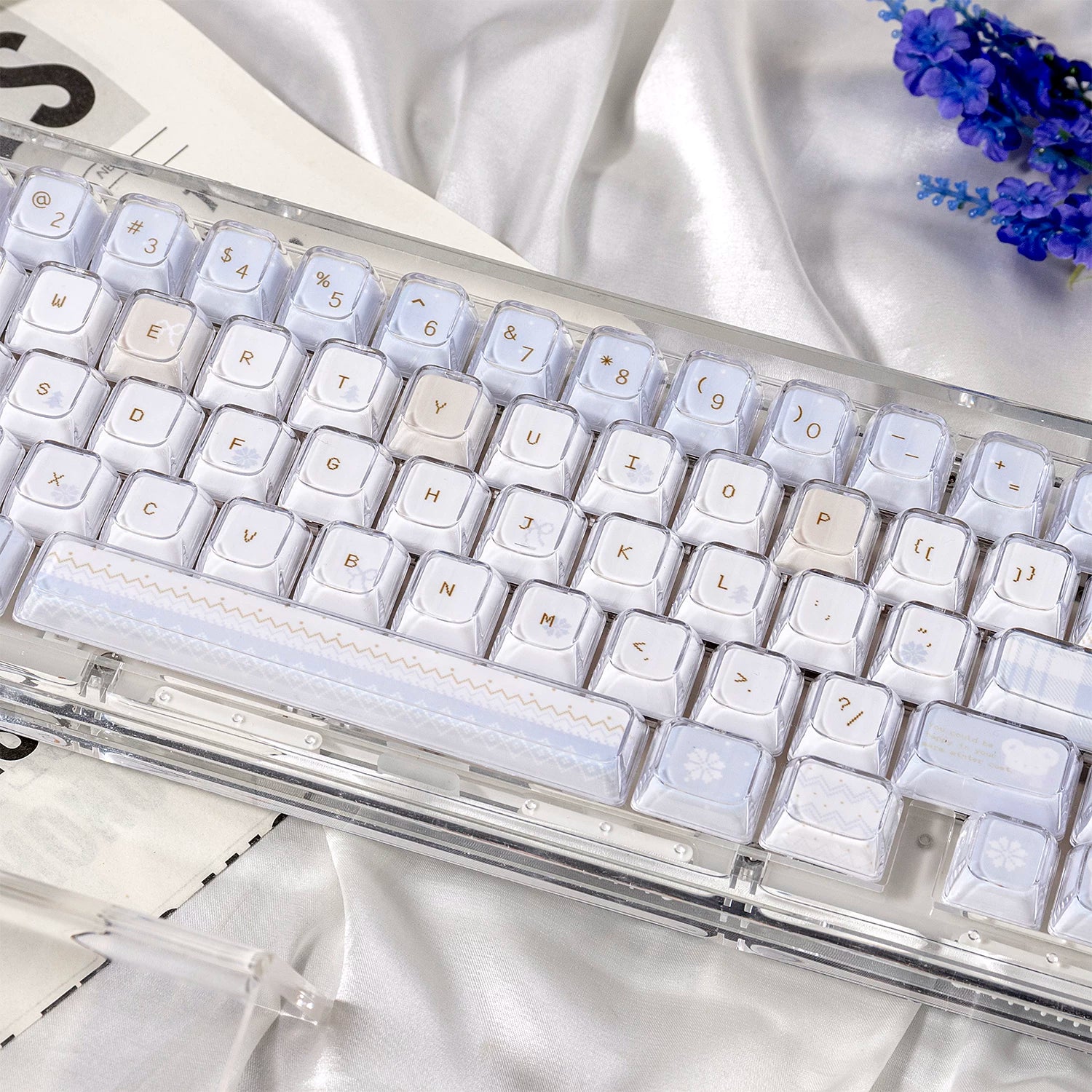 Mechanical keyboard with clear keycaps on a white fabric background
