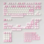 A set of pastel pink and white mechanical keyboard keycaps with cute illustrations, arranged on a light gray background.