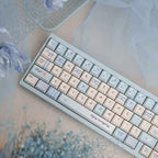 Keyboard with decorative keycaps on a soft surface with flowers