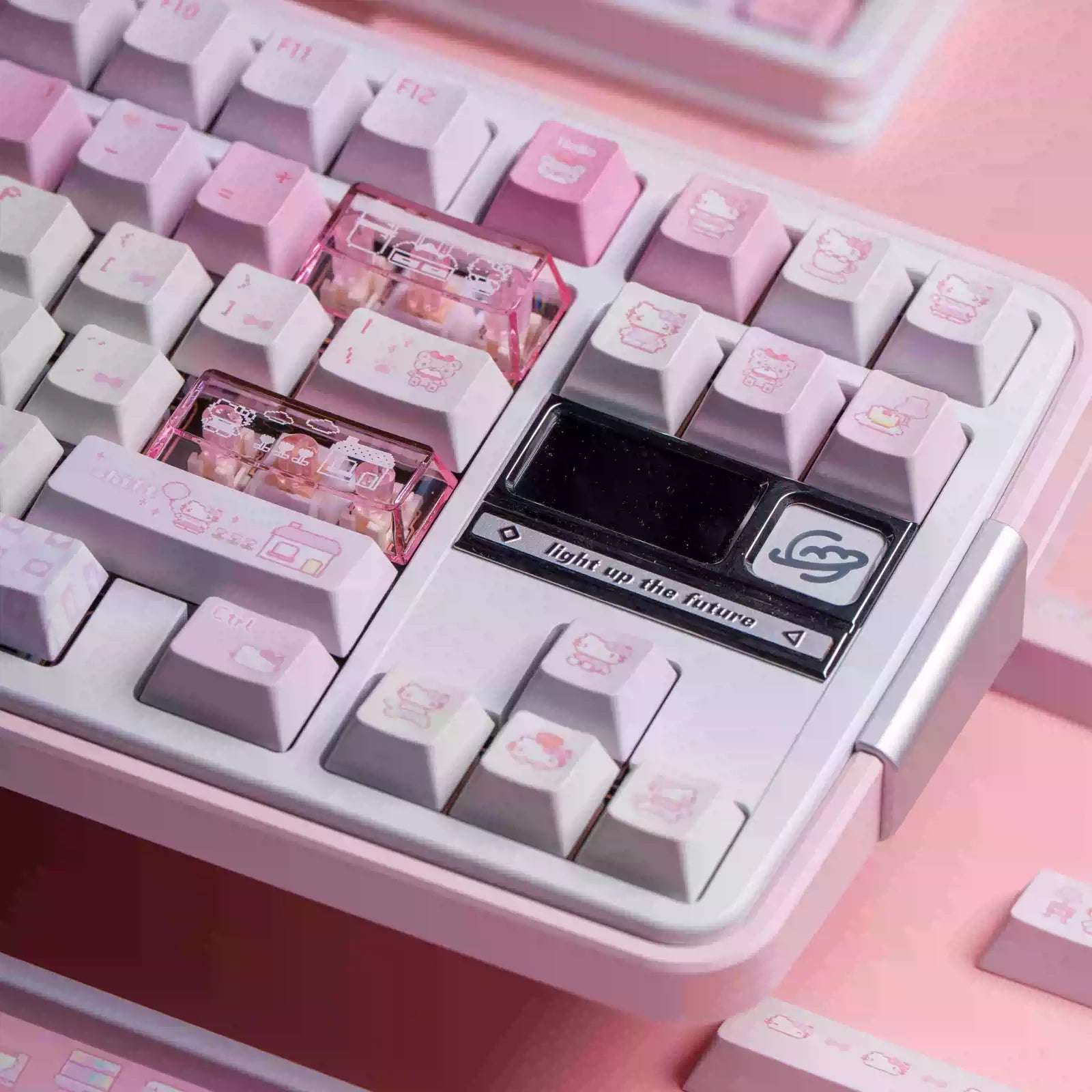A close-up of a pastel pink mechanical keyboard with white and pink keys, translucent pink switch capsules, and a black custom macro key labeled 'Light up the future' with a cloud icon.