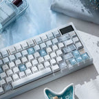 Mechanical keyboard with blue and white keycaps on a light surface