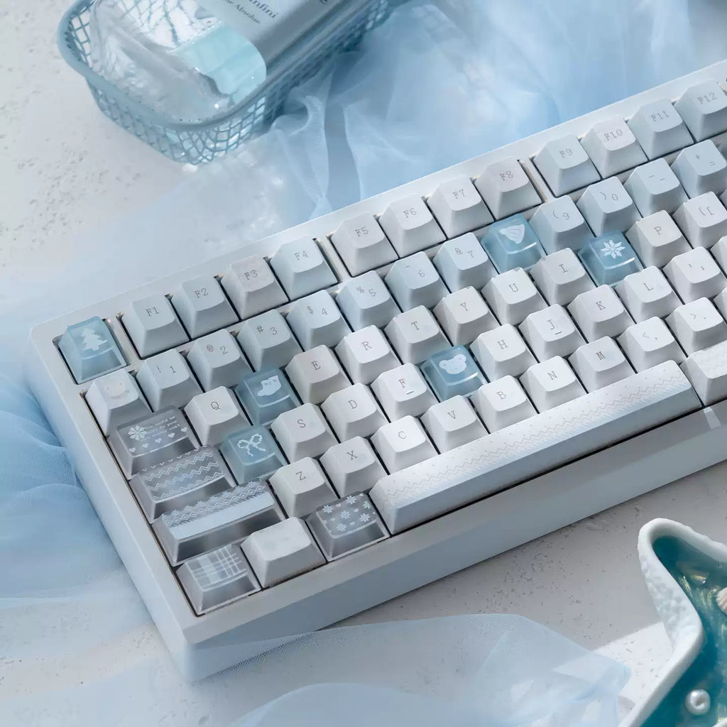 Mechanical keyboard with light blue and gray keys on a light surface