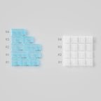 Two silicone molds on a gray background, one blue with measurements and the other clear with grid pattern.