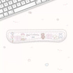 A long, narrow desk mat with a cute pastel cartoon design, placed on a white desk next to a keyboard. The desk mat features illustrations of a bunny, bear, sheep, and a fence, with the text 'Cute's dream' in the center.